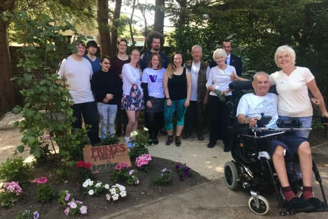 Care for Veterans staff, volunteers and resident Dudley with The Prince's Trust volunteers in the garden at the Boundary Road home for disabled ex-service personnel