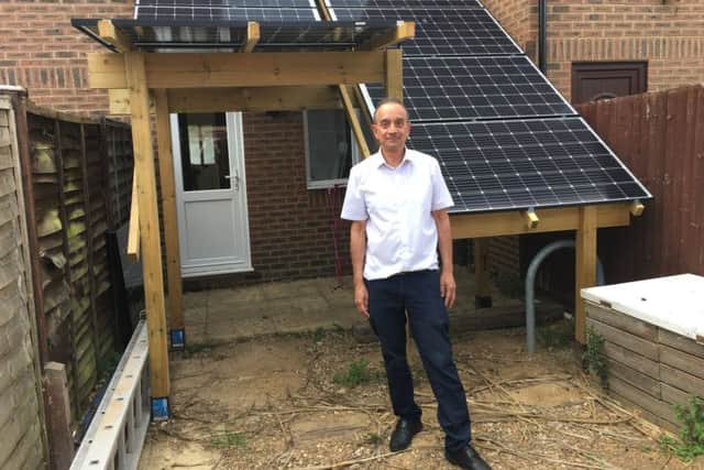 David Symons, 63, by the solar panel creation he made at his property in Little Pembrokes, Worthing