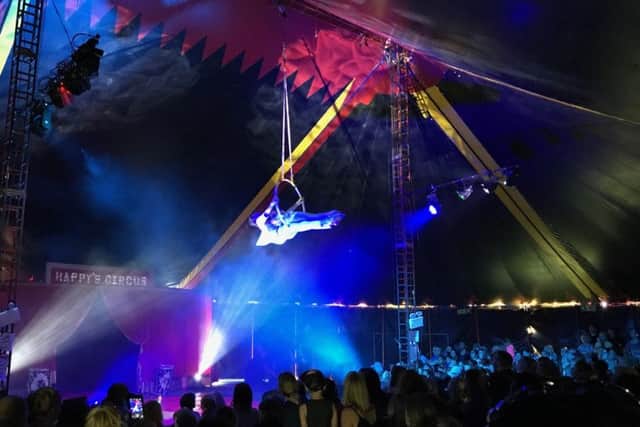 One of the aerialists, flying over the heads of the crowd