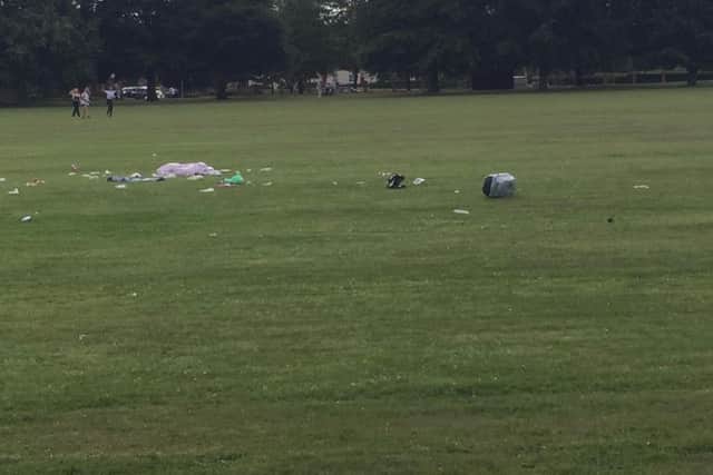 What appears to be bin bags, boxes and other litter strewn across the field.