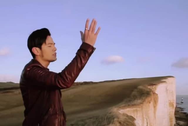 A still from Jay Chou's video What's Wrong? which features Beachy Head, the Seven Sisters, and the Belle Tout lighthouse