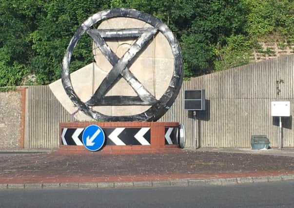 This Extinction Rebellion sign appeared on the Cuilfail sculpture in Lewes SUS-190407-080508008