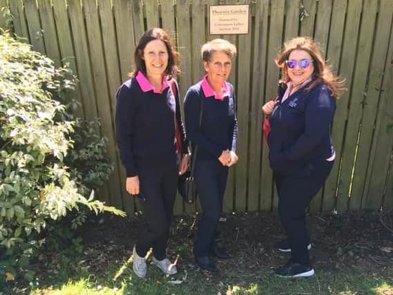Jill Lewis, Heather Skinner and Margaret Brice beside the garden nameplate donated by SL2 Designs