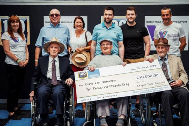 The Draper family presents a cheque for £10,000 to Care for Veterans