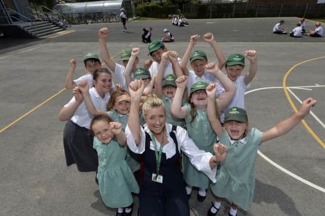 Head teacher Claire Martin-O'Donoghue and children celebrating Polegate School achieving flagship inclusion status (Photo by Jon Rigby)