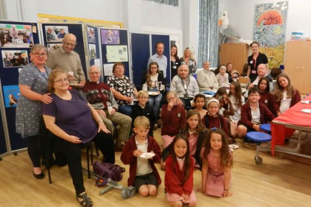 Bianca Donnelly, founder of Great 2 Create, right, Lis Telcs, teacher at Swiss Gardens Primary School, left, and Peter Hornsby, co-ordinator of Age UK West Sussexs Adur Community Clubs, centre, with year-five pupils and their guests at the community tea party
