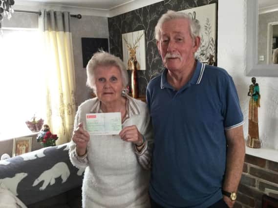 Rockinghorse Lotto agent Jeff Hayler (right) presented the cheque to Jean Street