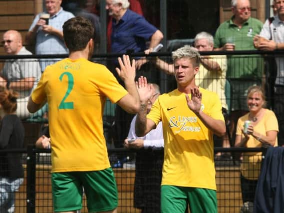 Chris Smith (right) celebrates opening the scoring in Horshams historic 3-1 home win over Crawley Town on Saturday. Photo by Derek Martin Photography
