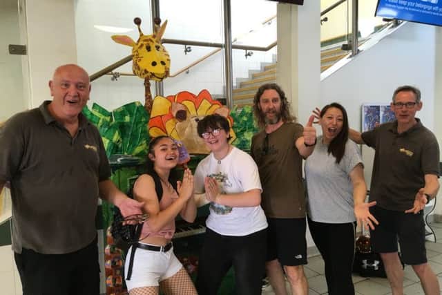 Andrew Smith, left, and Shaun Durrant, right, from Horsham Piano Centre with artist Annalees Lim, Horsham District Council community development manager Nick Jenkins and the first two members of the public to play the piano