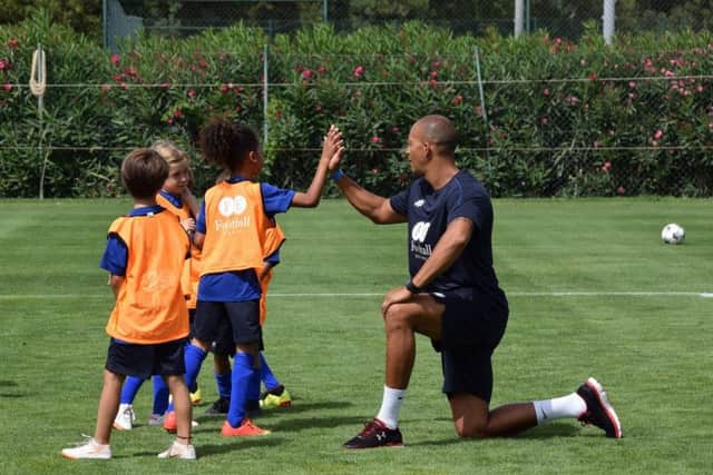 Bobby Zamora encourages the young footballers