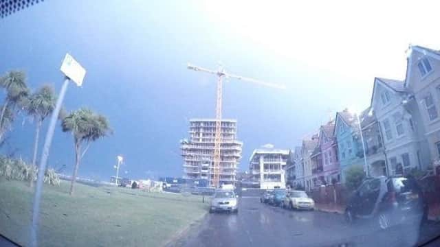 Lightning illuminates the Bayside apartments in Brighton Road