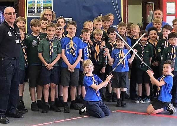 Neighbourhood Warden Chris Poore with the Storrington & Sullington Cub Scouts and their litter picking equipment SUS-190724-142910001