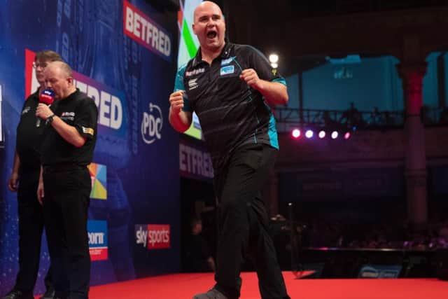 Rob Cross celebrates. Picture by Lawrence Lustig/PDC