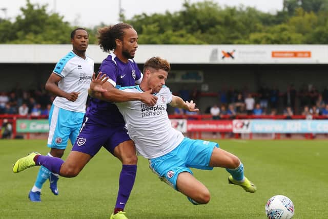 Crawley's Josh Doherty challenges for ball against Portsmouth's Marcus Harness. 
Photo by Joe Pepler