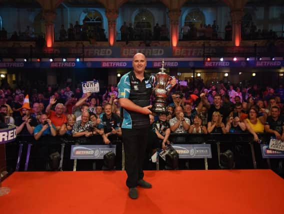 Rob Cross with the trophy. Picture by Chris Dean/PDC