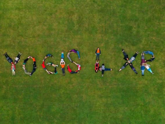 Brighton Yoga Foundation joins forces with Extinction Rebellion Brighton on the first day of Brighton Yoga Festival in a visual act of solidarity. Photograph: James Beer, 23 Digital