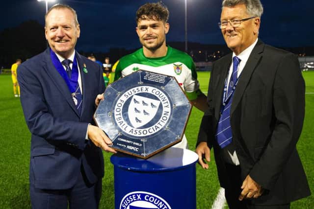 Rocks skipper Harvey Whyte with the community shield / Picture by Tommy McMillan