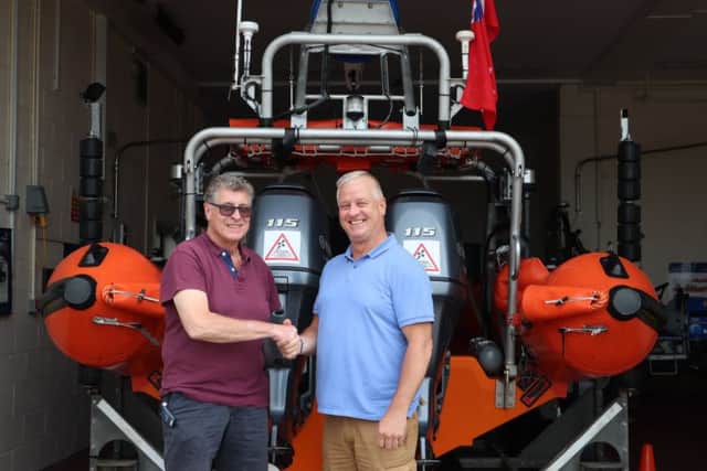 Tom Boltwood, right, presents a cheque to Littlehampton RNLI lifeboat operations manager Nick White in memory of Jessie Patterson