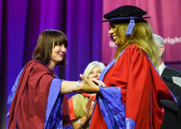 Transgender model Munroe Bergdorf after receiving an honorary doctor of letters at the University of Brighton graduation ceremony greets her lecturer Dr Jessica Moriarty
Photograph taken by Simon Dack SUS-190731-112324001