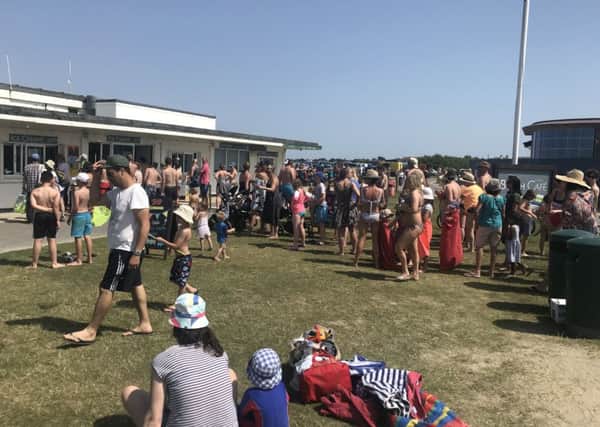 People queueing for ice-cream at West Wittering beach in July