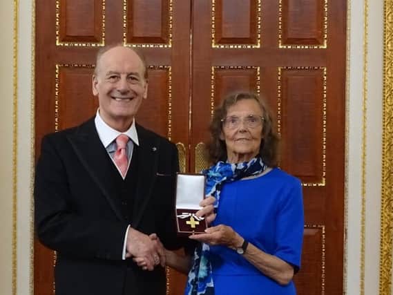 Win Ebanks receives her Order of Mercy medal
