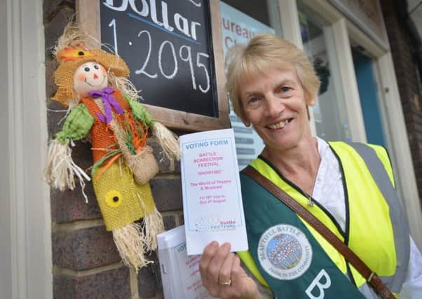 Battle Scarecrow Competition 2019.  Beautiful Battle member Ros Winter holding a scarecrow voting form. SUS-190719-131517001