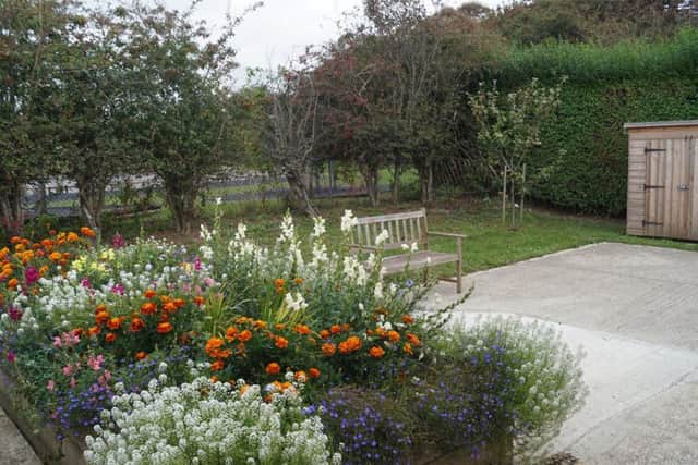The rear garden is a beautiful green space that contributes to members' mental health