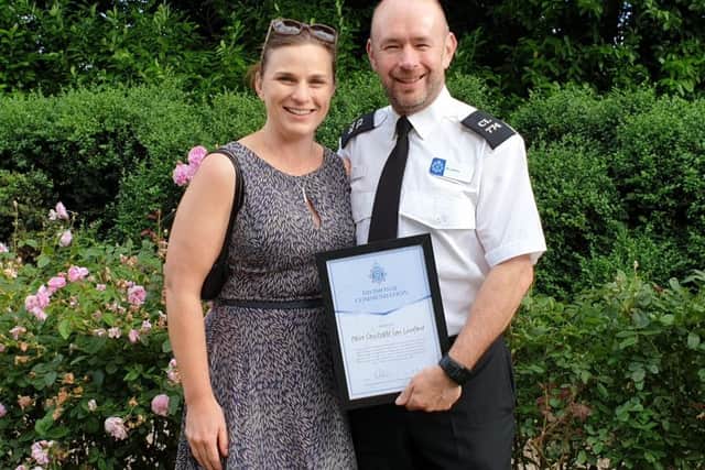 PC Luxford with his wife Kate and his award for helping a suicidal man