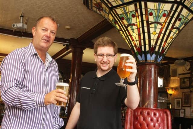 Gary May, new manager at the Grand Victorian Hotel in Worthing, with barman Josh Riley, right. Photo by Derek Martin DM1990017a