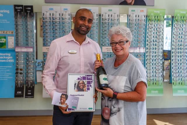 Lee Murphy collects her prize of champagne, a certificate and glasses voucher from Rishi Patel, store director at Specsavers Rustington branch