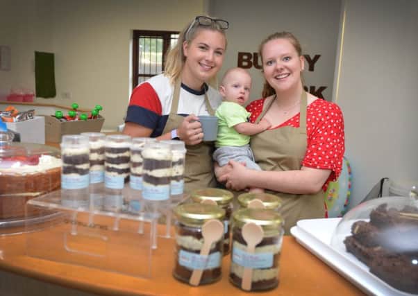 Café staff Amber Page and Alice Osborne with 9 month old Jake MacDonald