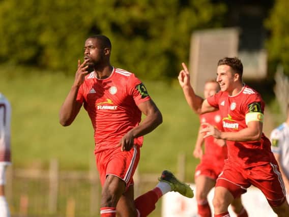 Substitute Shola Ayoola celebrates his late leveller at Hastings United. Picture by Marcus Hoare