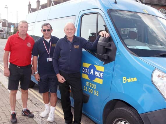 Dial-a-Ride bus renamed in honour of Brian Ingham, driver who died of a stroke. From left, Mark Hooper (from A-Z signs), driver Stuart Cooper and Gary Mills, manager. Photo by Derek Martin Photography.