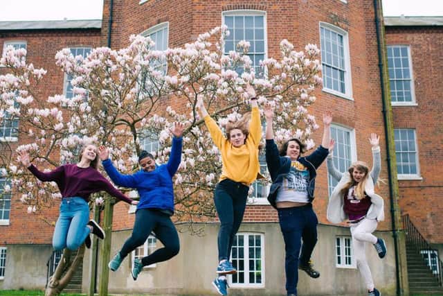 Students jumping outside the university