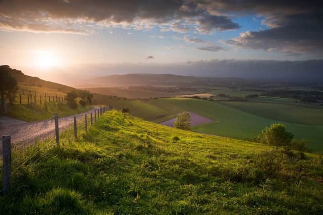 Stunning landscape at sunset over rolling English countryside SUS-191109-091538001