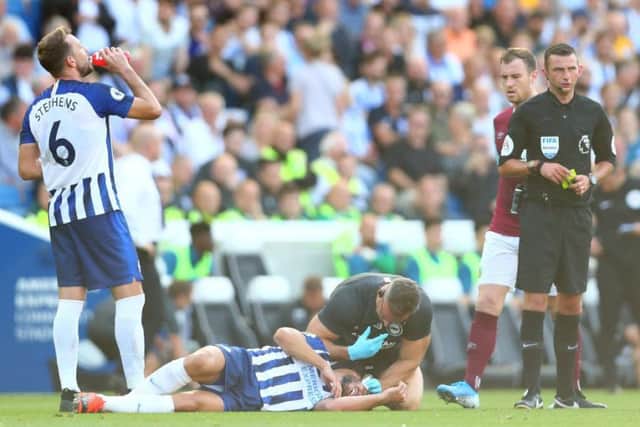 Neal Maupay receives treatment after a clash with Ashley Westwood (Getty)