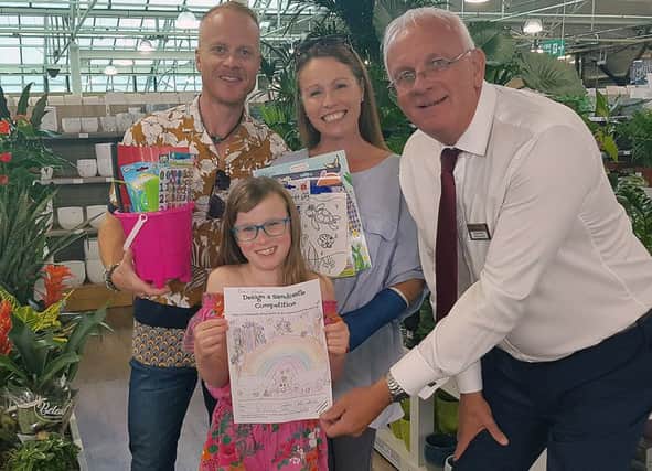 Enva with her parents receiving first prize from Paul Smythe