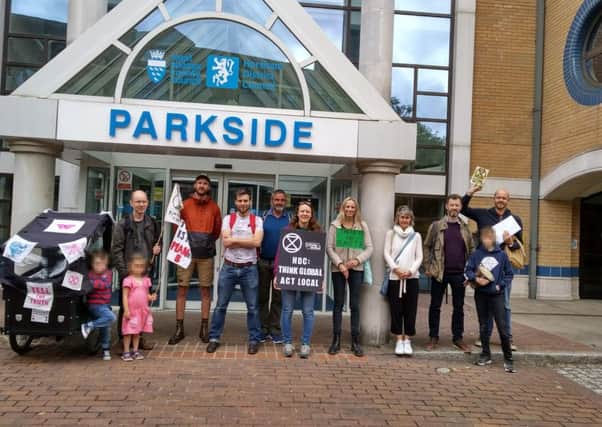 Extinction Rebellion (XR) Horsham members read the declaration of rebellion outside council offices at Parkside