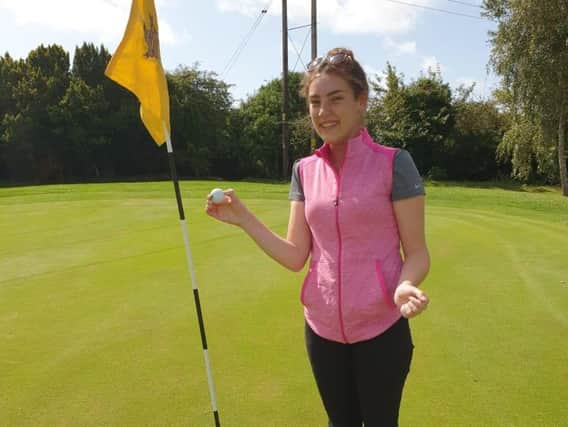 Katie Field celebrates her hole in one
