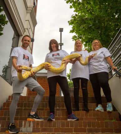Arnie, the Albino Burmese Python, will be staying at home while his owner, Luke Tyler of RepTylers leads the Walking for Lives Challenge on Sunday, October 6. Pictured with him is, left to right, The Montefiore Hospitals senior staff nurse Julie Gore, Candice Konig, director of Forward Facing, and Julies daughter, Jess.