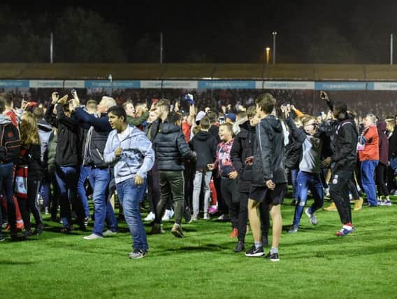 Crawley Town fans on the pitch after the Stoke City win