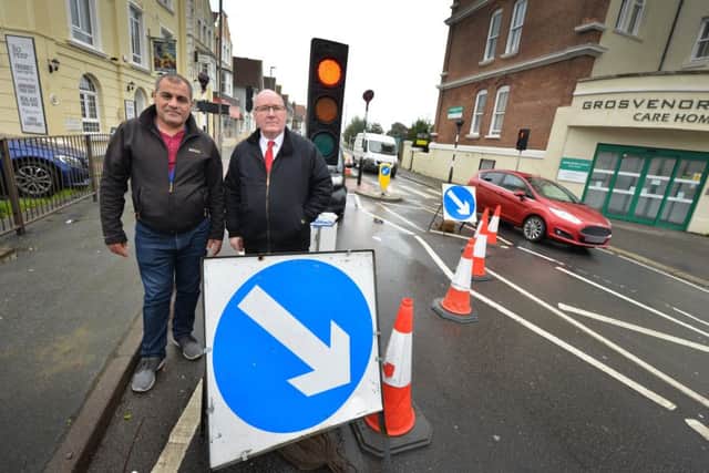 Councillor Phil Scott (right) with 247247 taxi driver Farhad Salihi by roadworks near to Grosvenor Gardens in St Leonards SUS-191016-122743001
