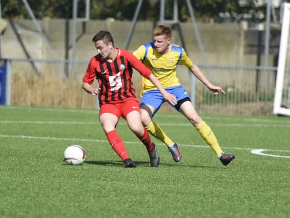 Football: Lancing v Worthing United. 14/09/2019. Pictured is Lancing's Liam Hendy and Worthing United's Joe Patching. LP191502