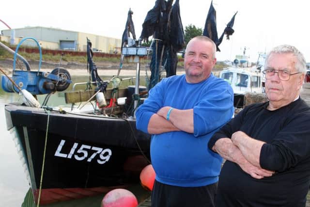DM19101770a.jpg. Fishermen angry by change to fishing laws which means they cannot fish near the shore. Sean Hunter, left and his dad Bill. Photo by Derek Martin Photography.