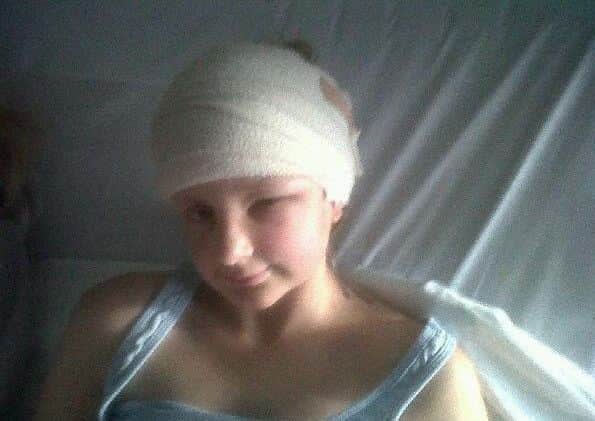 Izzy Colville in hospital after surgery. The Brain Tumour Charity.