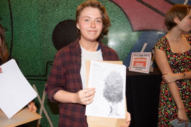 Libby Russell with an illustration of her poem by Chris Riddell