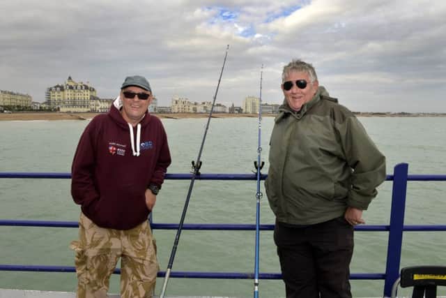 Eastbourne Pier Fishing- Opening Day - Michael Peckett, First man back on the pier,  fishing early morning and Alan Beasley (Photo by Jon Rigby) SUS-190710-082633008