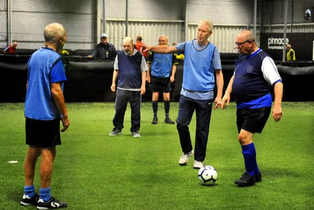 The walking football team members on the pitch