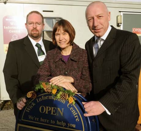 Julie Roby fro the Wick Information Centre with Barry Lane and Stuart Marshall from Morrisons in 2012, when the grant was given