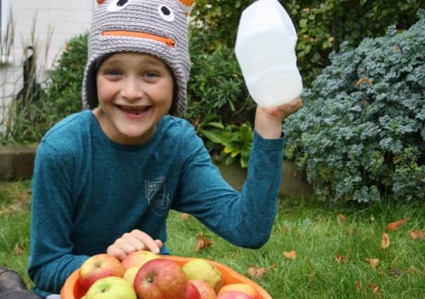 Oscar Nelson, 7, gets ready for Apple Pressing Day in Bury